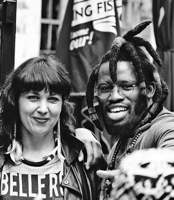 Greyscale Photo of Woman and Man Standing While Smiling