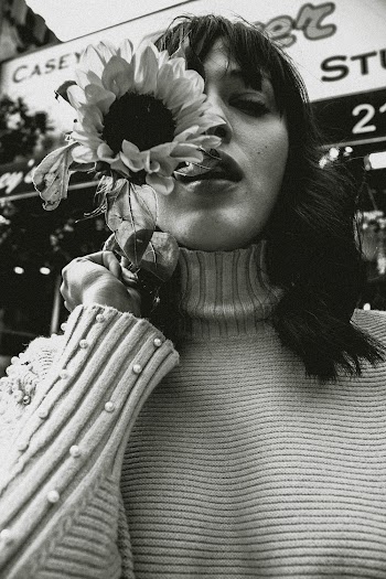 Greyscale Photo of Woman Holding Sunflower