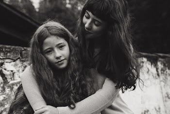 Greyscale Photo of Woman Hugging Other Woman