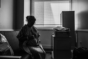 Greyscale Photo of Woman Sitting on Chair