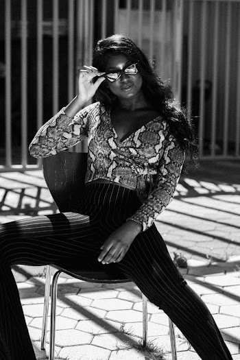 Greyscale Photo of Woman Sitting on Chair