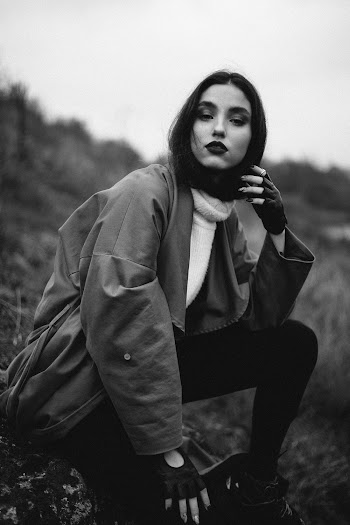 Greyscale Photo of Woman Wearing Coat
