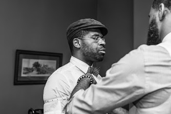 Greyscale Photography of A Man Being Measured By A Tailor