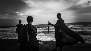Greyscale Photography of Three Monks Near Ocean