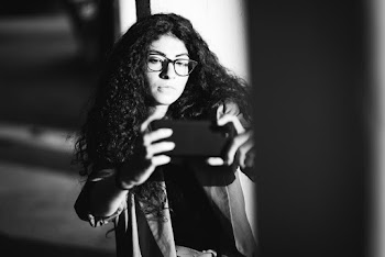 Greyscale Photography of Woman Holding Smartphone