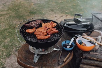 grilled meat and sausages on top of grill