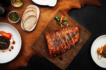 grilled meat beside breads