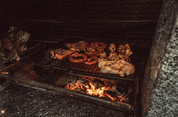Grilled Meat on Black Charcoal Grill at Nighttime