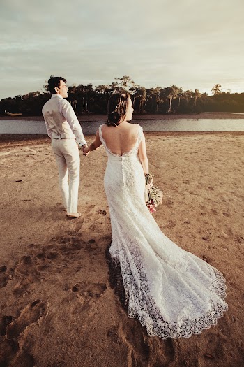 Groom and Bride Standing Near Body of Water