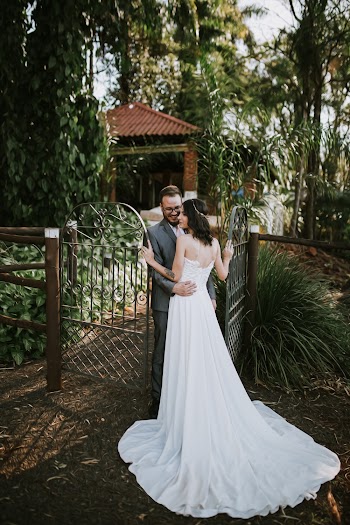 Groom and Bridge Standing Near Gate