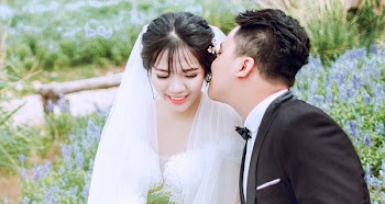 Groom Kissing Bride on Left Cheek