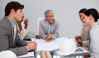 Group of architects studying plans in a meeting