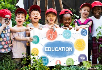 Group of children holding blank blackboard in garden