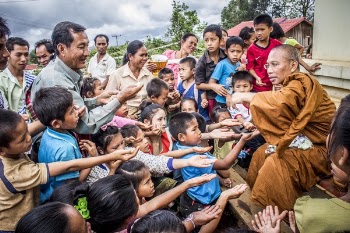 Group of Children Raising Their Palm Towards a Man