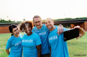 Group of diverse volunteers taking selfie together