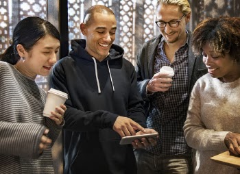 Group of Men and Women Smiling While Looking at Phone