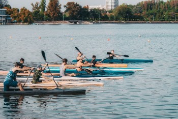 Group of Men Riding on Boats