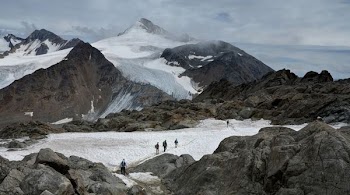 group of people hiking on snowy mountains