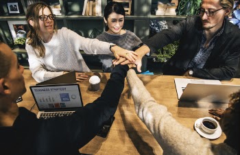 Group of People Holding Hands Forming Teamwork