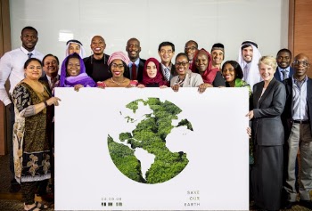Group of People Holding Save Our Earth Poster