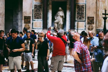 Group of People Inside Museum Taking Pictures of Antiques