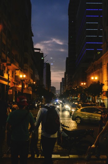 Group of People on Road Near High-rise Buildings