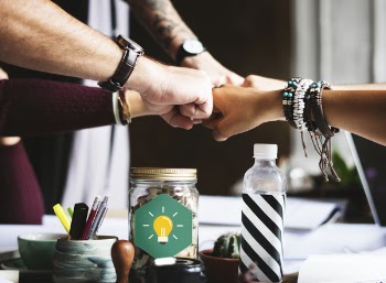 Group of People Putting Fist on Center