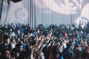 group of people raising their hands