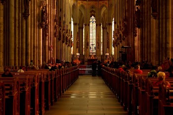 Group of People Sitting on Cathedral Bench