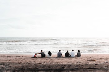 Group of People Sitting on Seashore