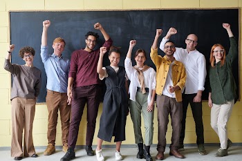 Group of People Standing infront of Blackboard · Free Stock Photo