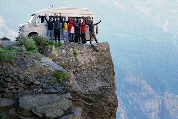 Group of People Standing on A Cliff