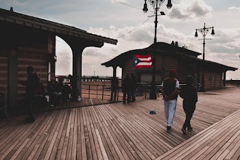 Group of People Standing on Brown Wooden Floor