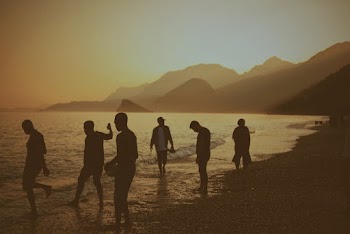 Group of People Standing on Shoreline