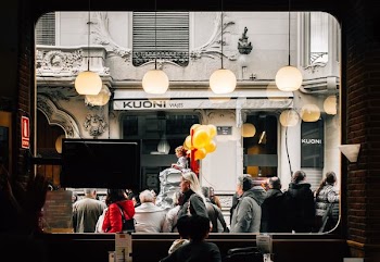 group of people standing outside room