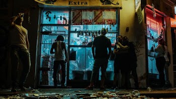 group of people standing outside store