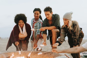Group Of People Toasting Marshmallows On Stick