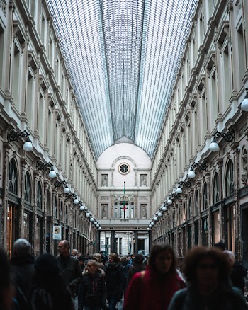 Group of People Walking on Hallway Inside Building