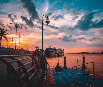 Group of People Watching Sunset on Harbor