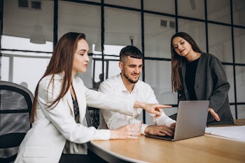 Group of people working out business plan in an office Free Photo