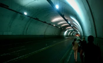 Group of Persons Passing by Tunnel