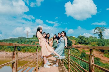 Group of Women Standing on Brown Bridge