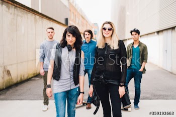 Group of young friends posing on road