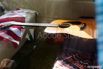 Guitar and American Flag on Van Rear Seat Road Trip Travel Journey