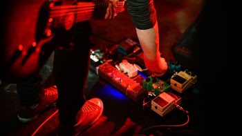 guitarist adjusting guitar effects