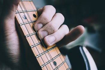 Guitarist hand playing guitar