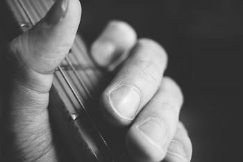 Guitarist hand playing guitar closeup 2