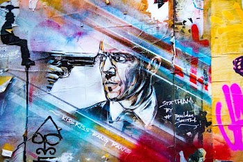 gun pointed on man's eye painting