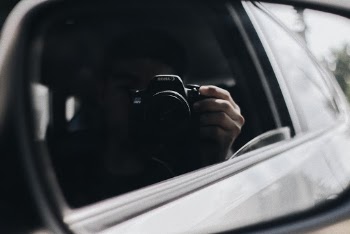 Guy taking a photo of himself in the car mirror