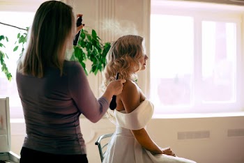 Hair Stylist Spraying Bride's Hair